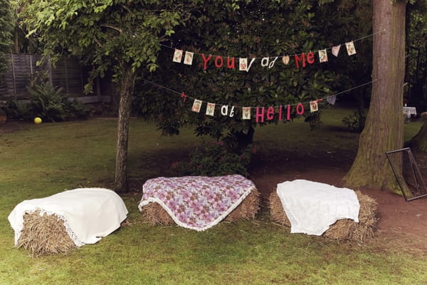 Bails of hay as seating at 1950s wedding reception - Picture by Ian Shoots Weddings