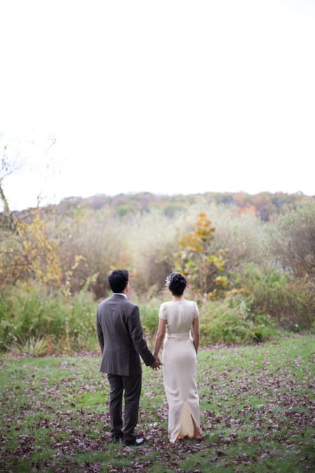 Bride and groom holding hands looking at view - Picture by Levi Stolove Photography