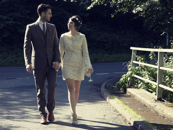 Bride and groom walking holding hands - Picture by Ian Shoots Weddings