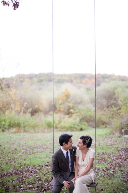 Bride and groom stitting on swing - Picture by Levi Stolove Photography
