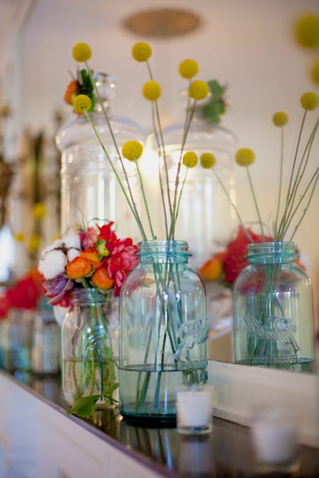 Jars of wedding flowers on shelf - Picture by Rojo Foto Design