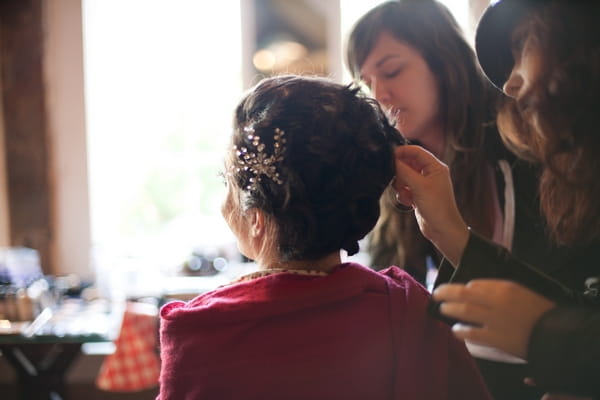 Bride having her hair done for her wedding - Picture by Levi Stolove Photography
