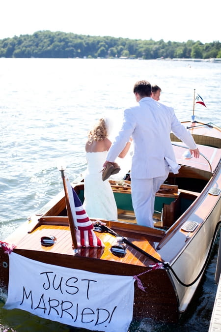 Bride and groom getting into boat - Picture by Laura Ivanova Photography