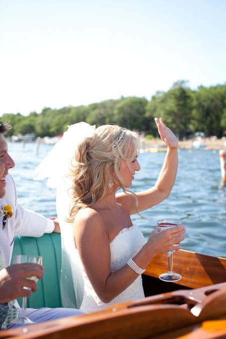 Bride waving from boat - Picture by Laura Ivanova Photography