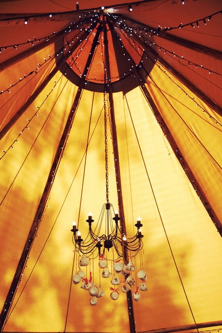 Chandelier hanging inside tipi - Picture by Ian Shoots Weddings