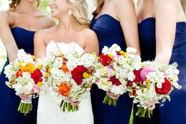 Bride and bridesmaids holding bouquets - Picture by Laura Ivanova Photography