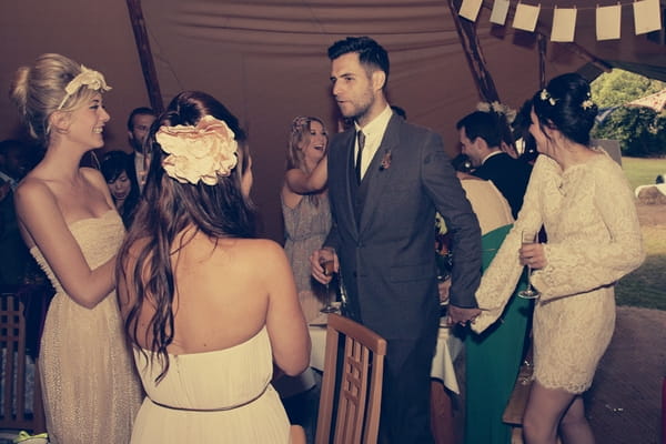 Bride and groom entering tipi wedding reception