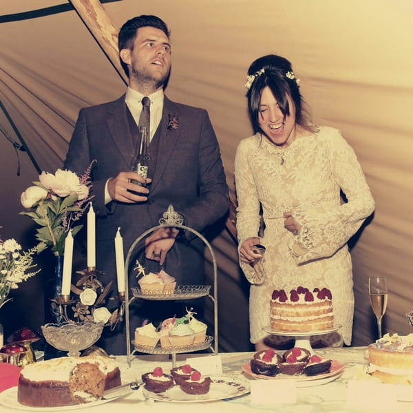 Bride and groom about to cut wedding cake - Picture by Ian Shoots Weddings