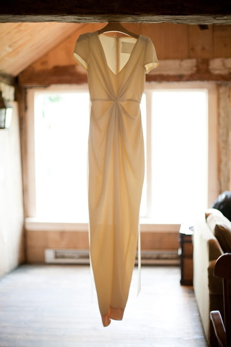 Wedding dress hanging from a beam - Picture by Levi Stolove Photography