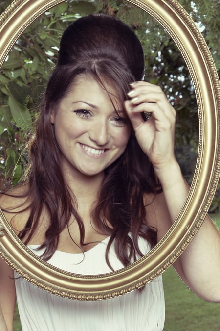 Bridesmaid smiling behind picture frame - Picture by Ian Shoots Weddings