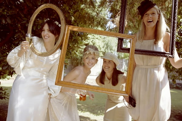 Bride and bridesmaids posing with picture frames - Picture by Ian Shoots Weddings