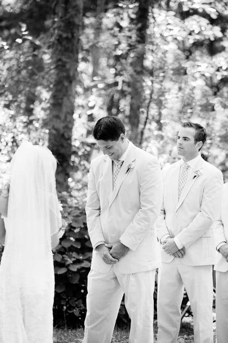 Groom looking down at wedding ceremony - Picture by Laura Ivanova Photography