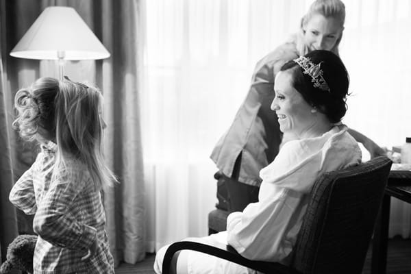 Bride sitting in chair talking to flower girl - Picture by Hayley Ruth Photography