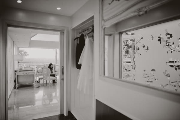 Hallway with wedding dress hanging up - Picture by Jonas Peterson Photography