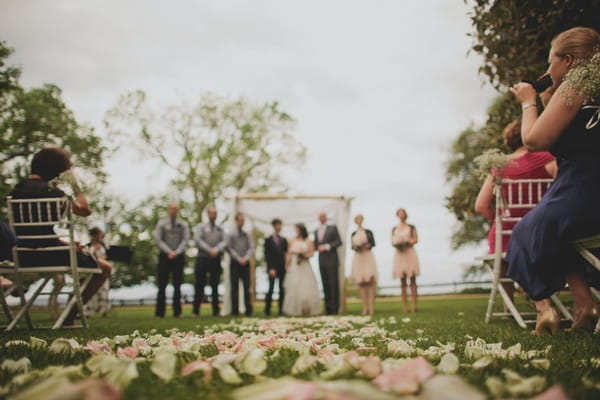 Petals on grass of wedding ceremony - Picture by Jonas Peterson Photography