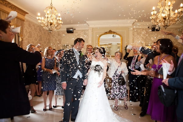 Bride and groom being showered in confetti - Picture by Hayley Ruth Photography