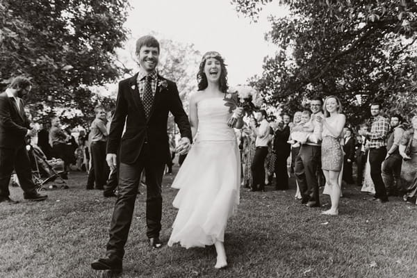 Happy bride and groom walking out of wedding ceremony - Picture by Jonas Peterson Photography