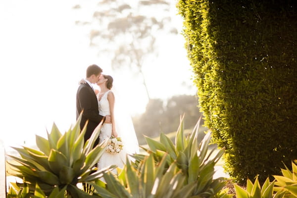 Bride and groom kissing - Picture by Allyson Magda Photography