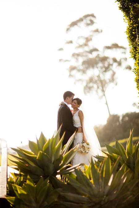 Groom whispering in bride's ear - Picture by Allyson Magda Photography