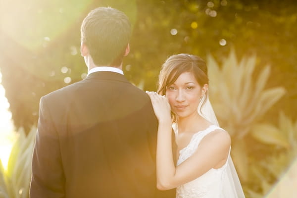 Bride with hand on groom's shoulder - Picture by Allyson Magda Photography