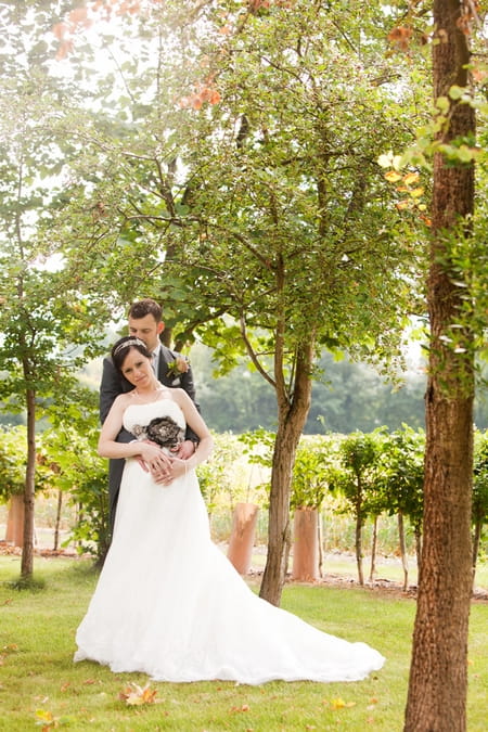 Groom with arms around bride's waist - Picture by Hayley Ruth Photography