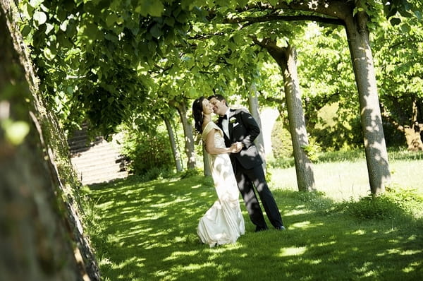 Bride and groom surrounded by trees - Picture by Gill Maheu Photography