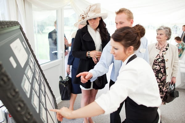 Guests looking at wedding table plan - Picture by Hayley Ruth Photography