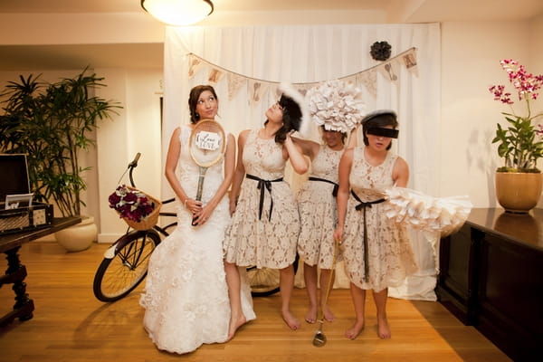 Bride and bridesmaids posing with props - Picture by Allyson Magda Photography