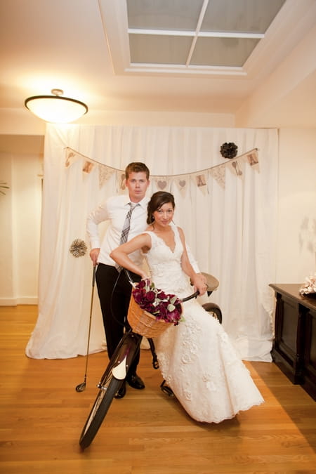 Bride and groom sitting on push bike - Picture by Allyson Magda Photography