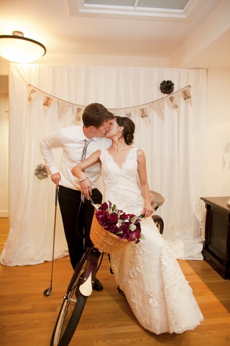 Bride and groom kissing on push bike - Picture by Allyson Magda Photography