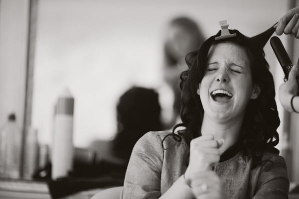 Bride laughing as she has her hair done - Picture by Jonas Peterson Photography