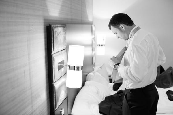 Groom doing up his cravat - Picture by Hayley Ruth Photography