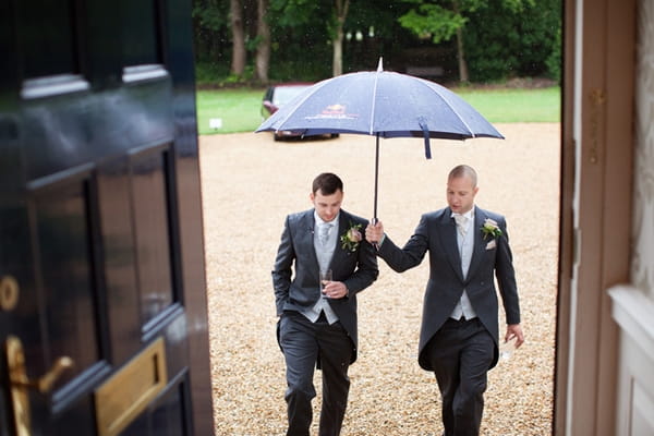 Best man holding umbrella over grrom - Picture by Hayley Ruth Photography