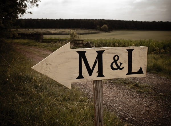 Wooden arrow sign with M & L - Picture by Archibald Photography