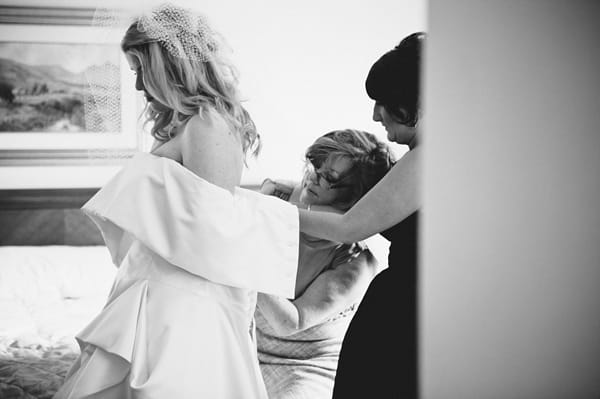 Bride putting on wedding dress - Picture by McKinley-Rodgers Photography