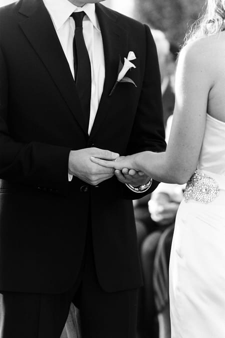 Groom placing ring on bride's finger - Picture by Yvette Roman Photography