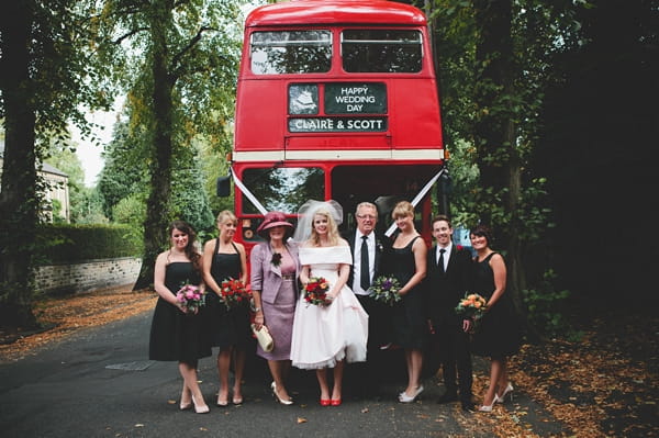 Bridal party in front of red bus - Picture by McKinley-Rodgers Photography