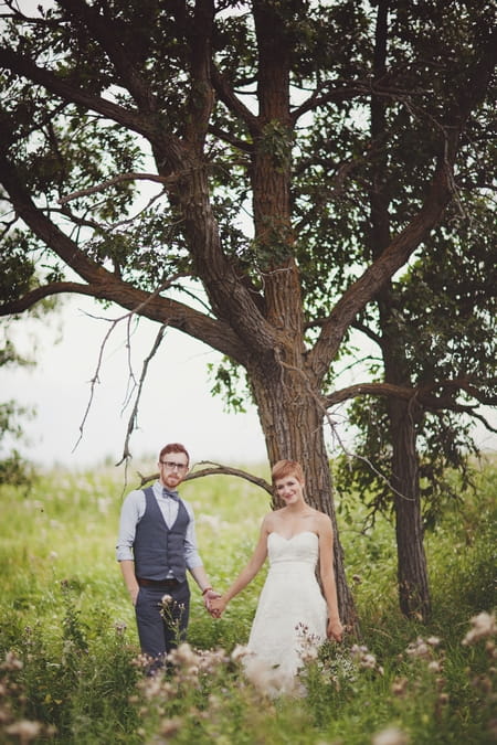 Bride and groom holding hands under a tree - Picture by Josh Dookhie Photography