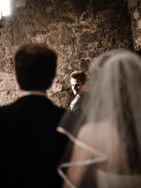 Groom looking round as bride approaches altar - Picture by Archibald Photography