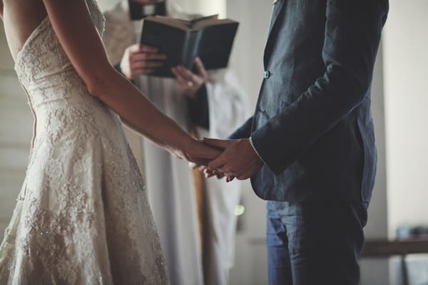 Bride and groom holding hands in wedding ceremony - Picture by Josh Dookhie Photography