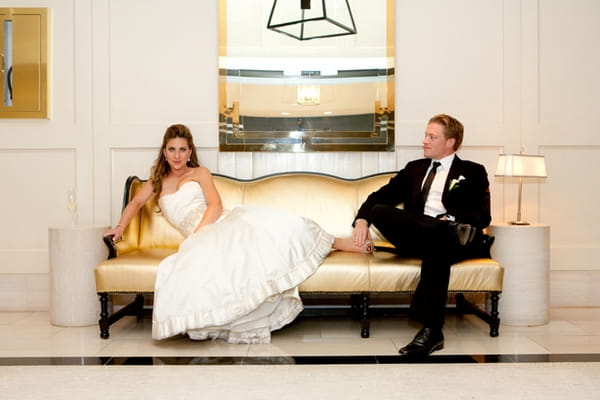 Bride laying on chez lounge with groom - Picture by Yvette Roman Photography