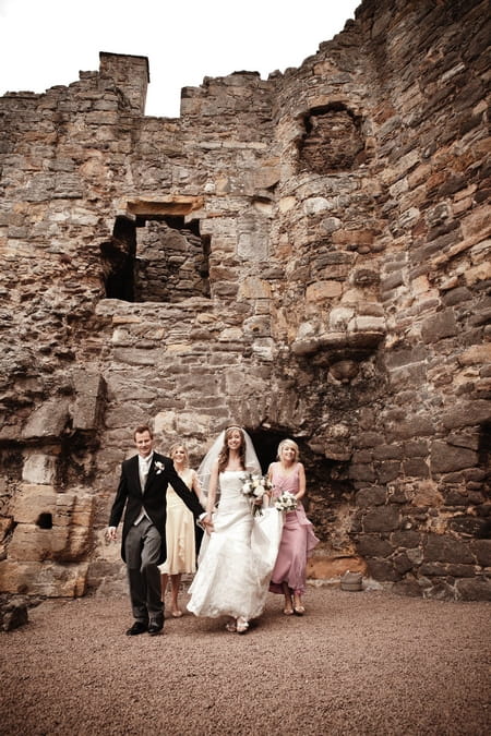 Bridal party leaving ceremony room at Dirleton Castle - Picture by Archibald Photography