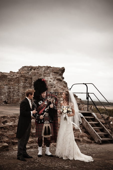 Bride and groom with bagpipe player - Picture by Archibald Photography