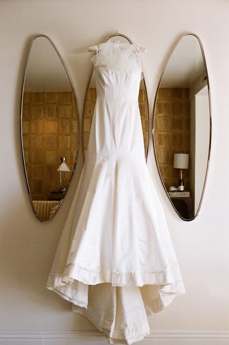 Wedding dress hanging on a mirror - Picture by Yvette Roman Photography