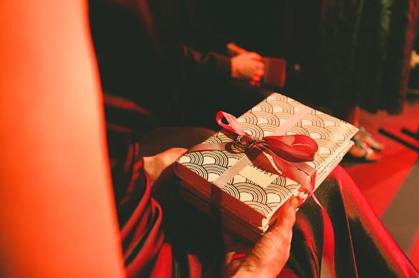 Wedding guest holding books - Picture by McKinley-Rodgers Photography