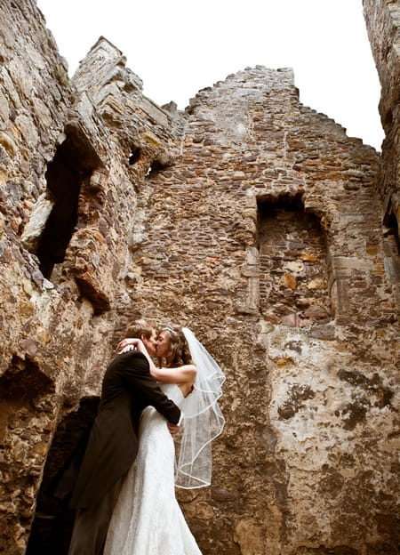 Bride and groom kissing at Dirleton Castle - Picture by Archibald Photography