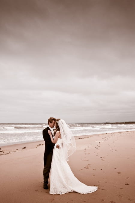 Bride and groom on beach - Picture by Archibald Photography