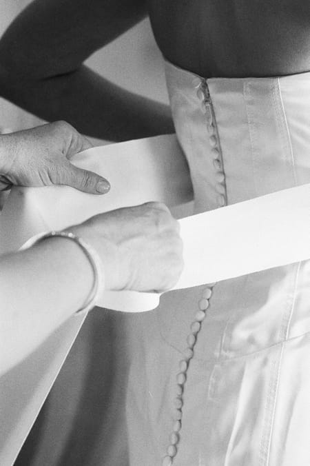 Wedding dress being done up - Picture by Yvette Roman Photography