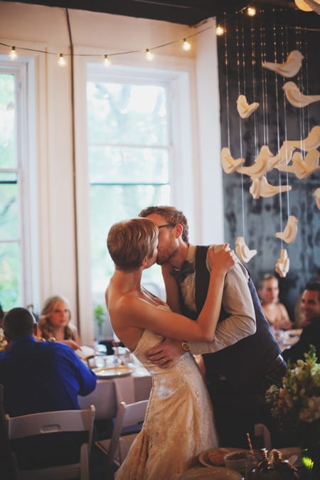 Bride and groom kiss at wedding reception - Picture by Josh Dookhie Photography