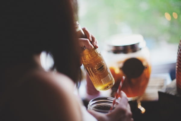 Wedding guest drinking a bottle of beer - Picture by Josh Dookhie Photograph